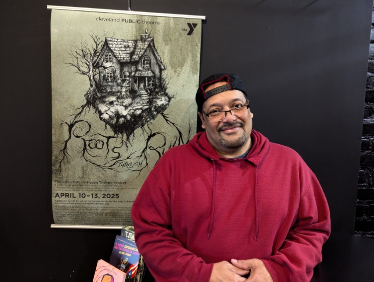 Y-Haven resident and "Roots through Ruin" cast member Ezequiel Soto stands by poster.
